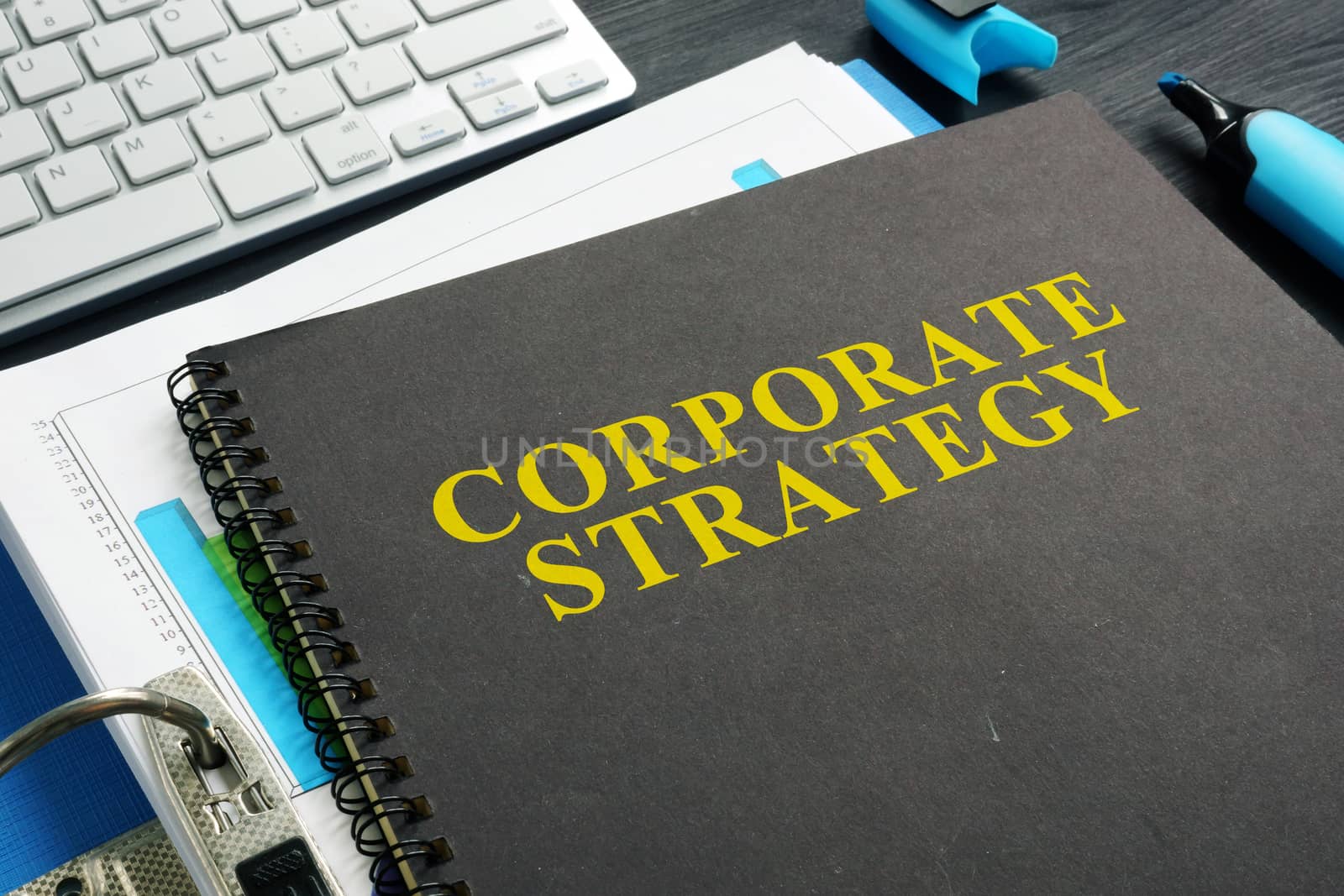 Corporate strategy plan and documents on a desk.