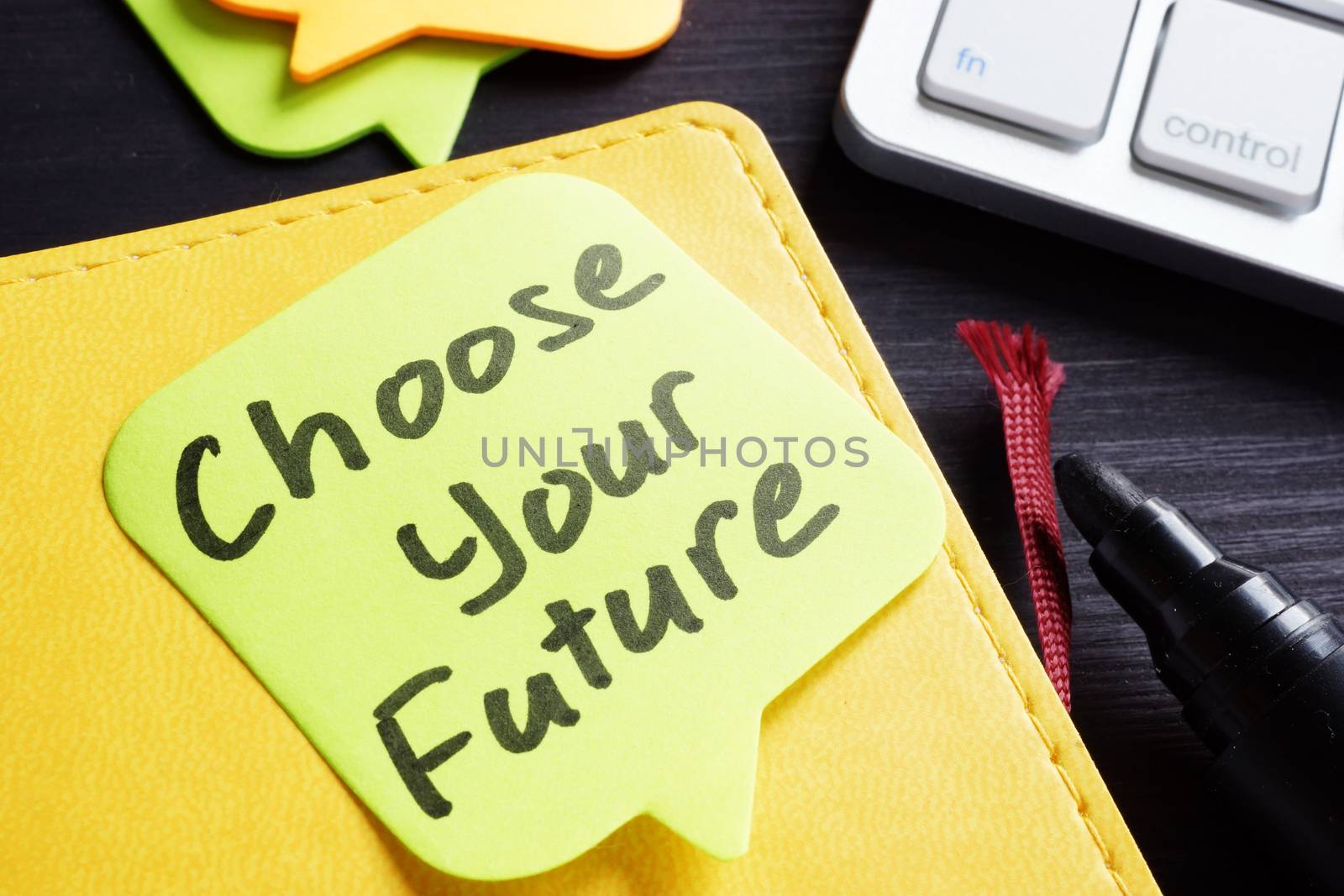 Choose your future written on a memo stick and pen.