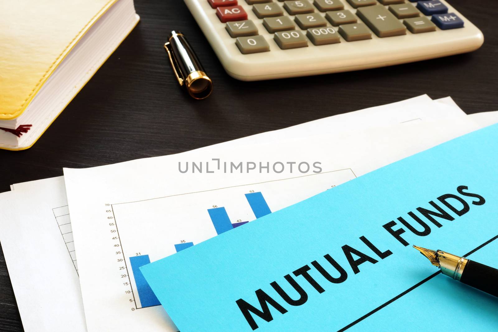 Financial documents about mutual funds on a desk.