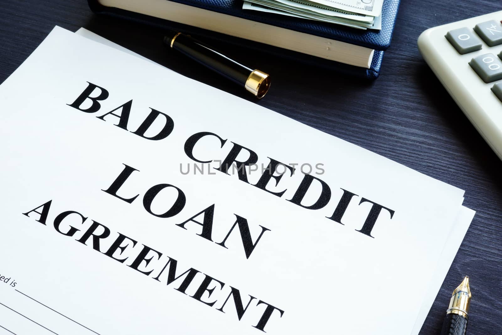 Bad credit loan agreement, dollars and pen.