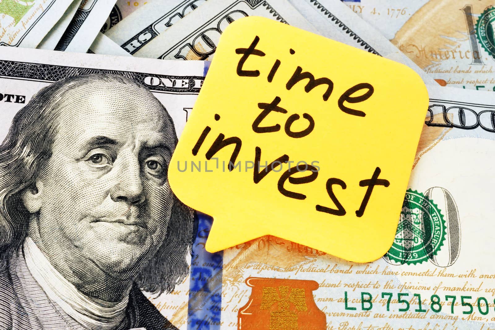 Time to invest concept. Memo stick and money.
