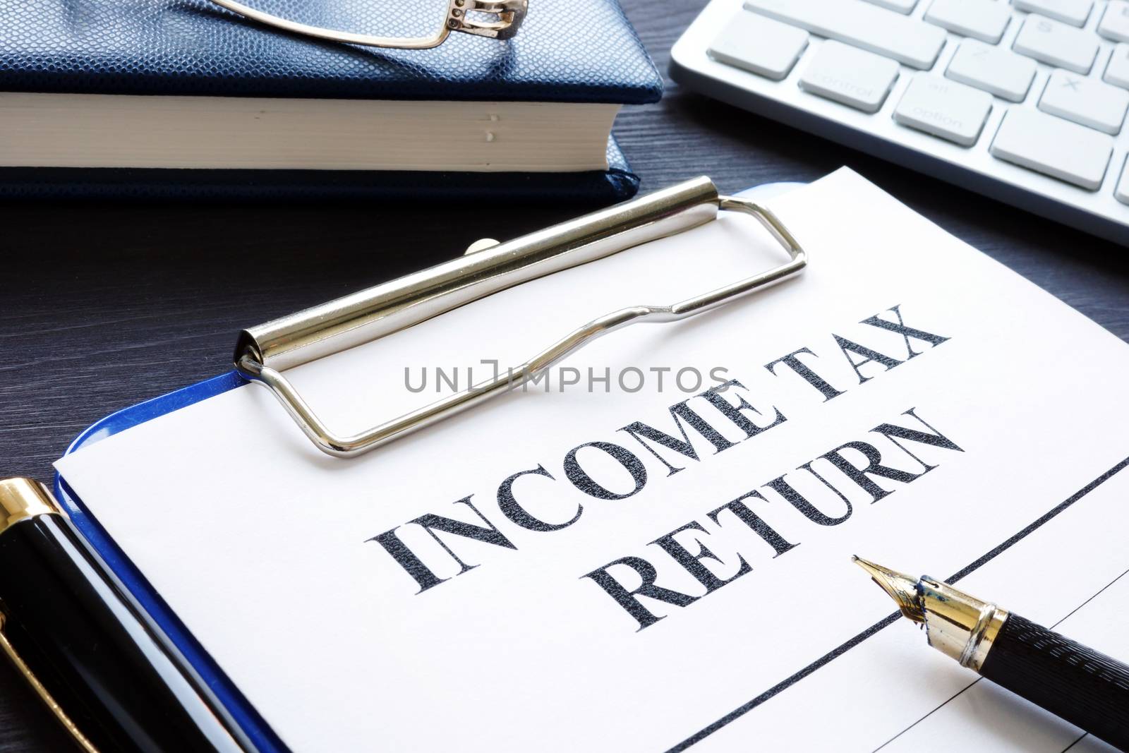 Income tax return documents and pen on a desk.
