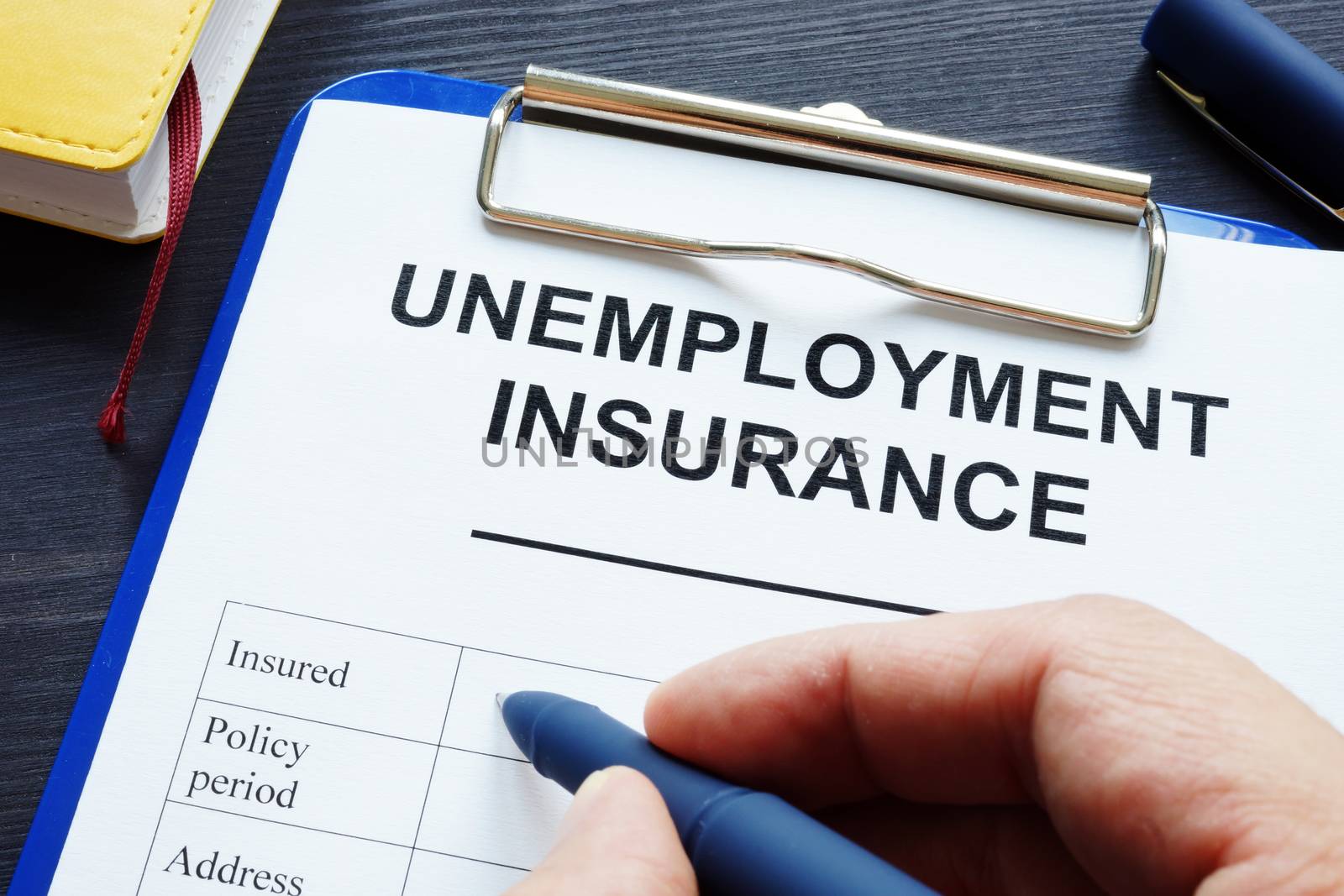 Man is filling in unemployment insurance in the office.