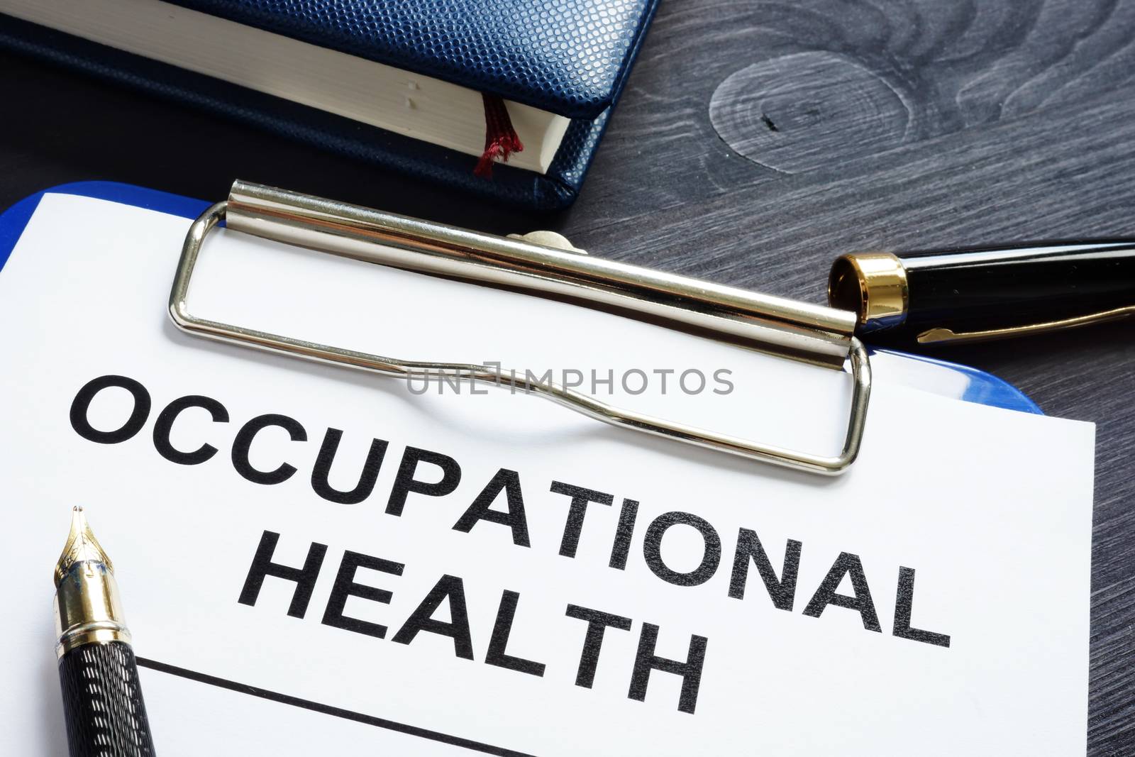 Occupational health report, pen and notepad.