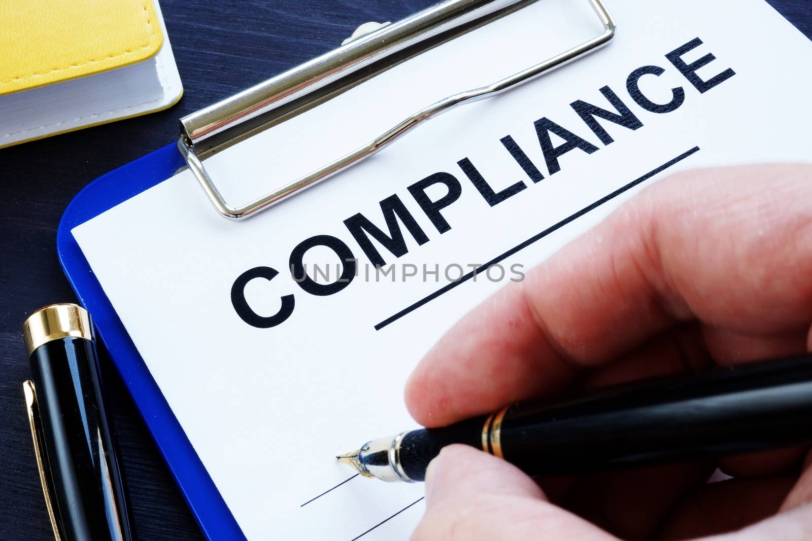 Man is filling in a compliance form.