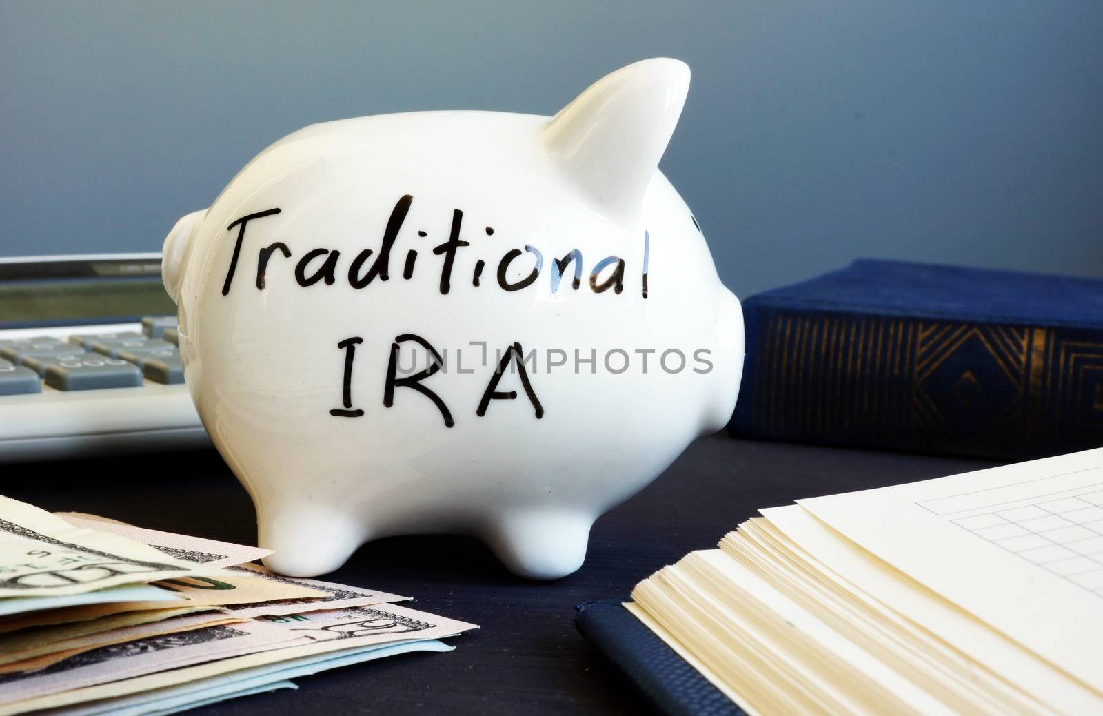 Traditional ira handwritten on a side of piggy bank.