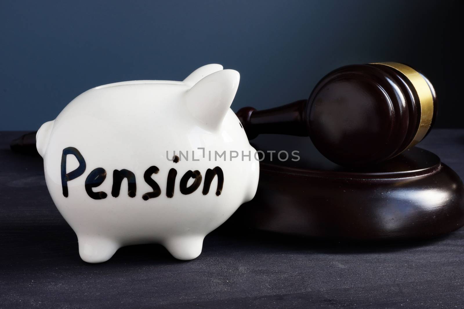 Gavel and piggy bank with sign pension. Legal and law concept.
