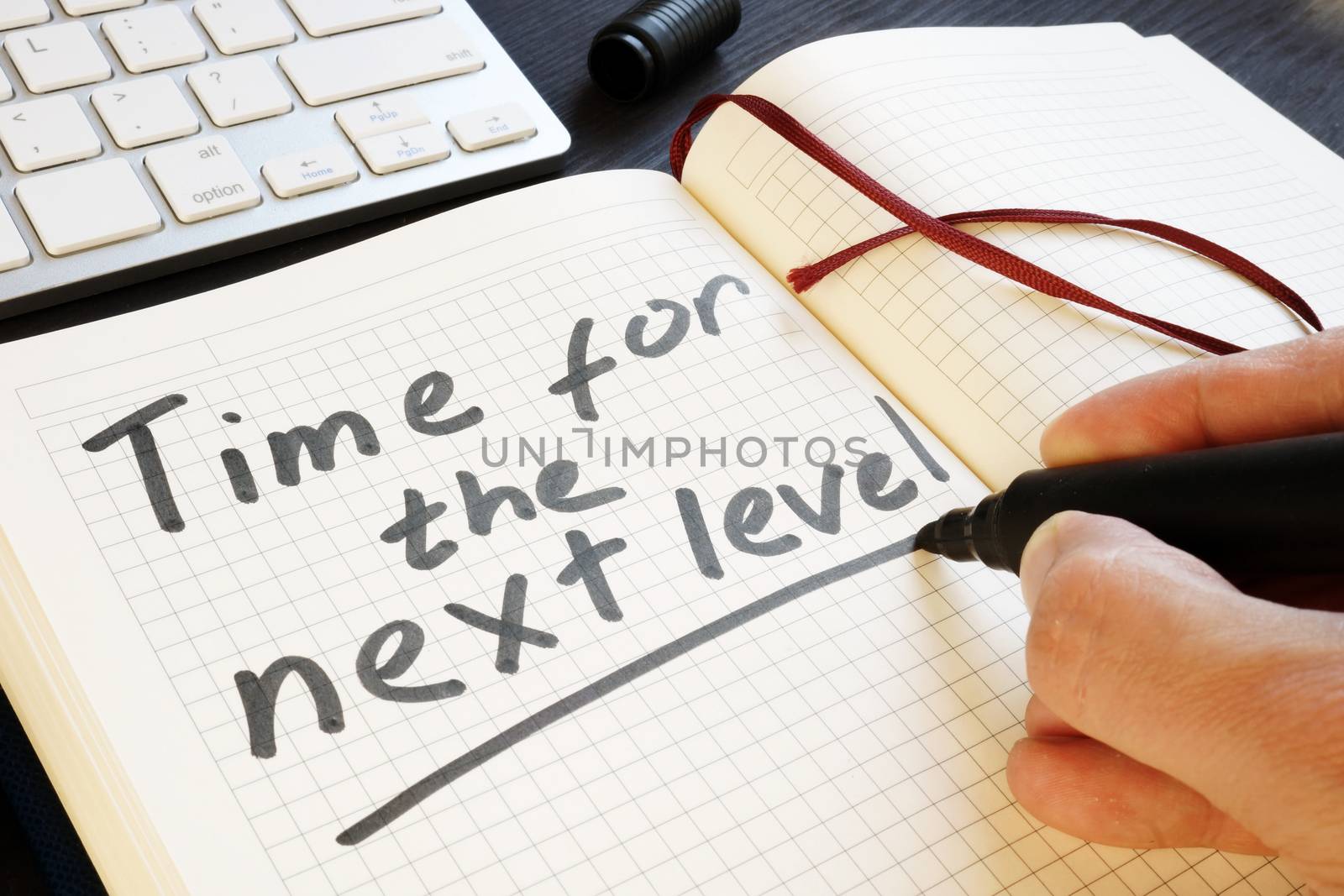 Man is writing time for the next level. Motivation.