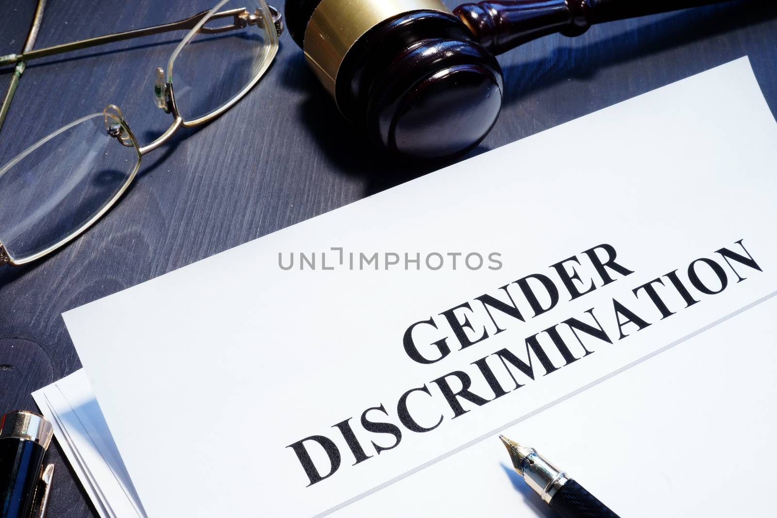Document about Gender Discrimination and gavel on a desk.