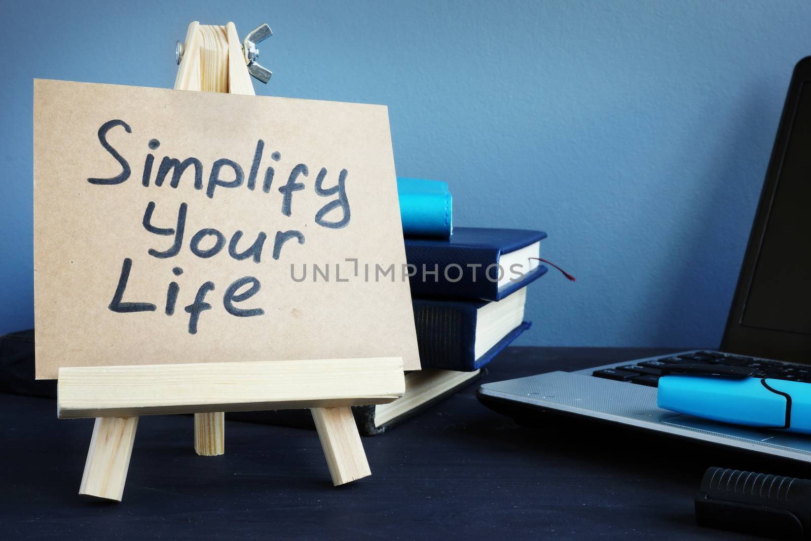 Simplify your life written on a piece of paper. by designer491