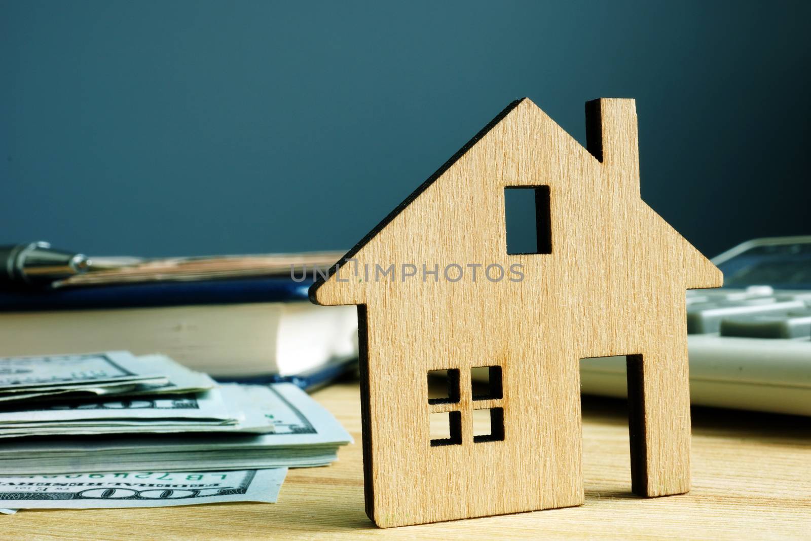 Model of house and money. Buy property or mortgage.