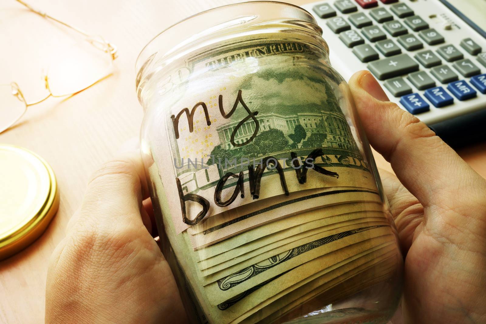 Jar with dollars and sign my bank on a side. Home finances and savings concept. by designer491