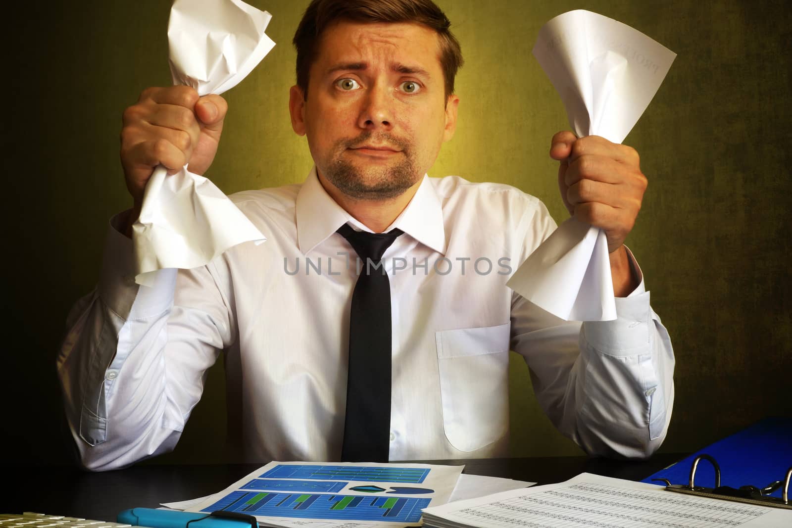 Nervous businessman observing bills. Problems in a business.