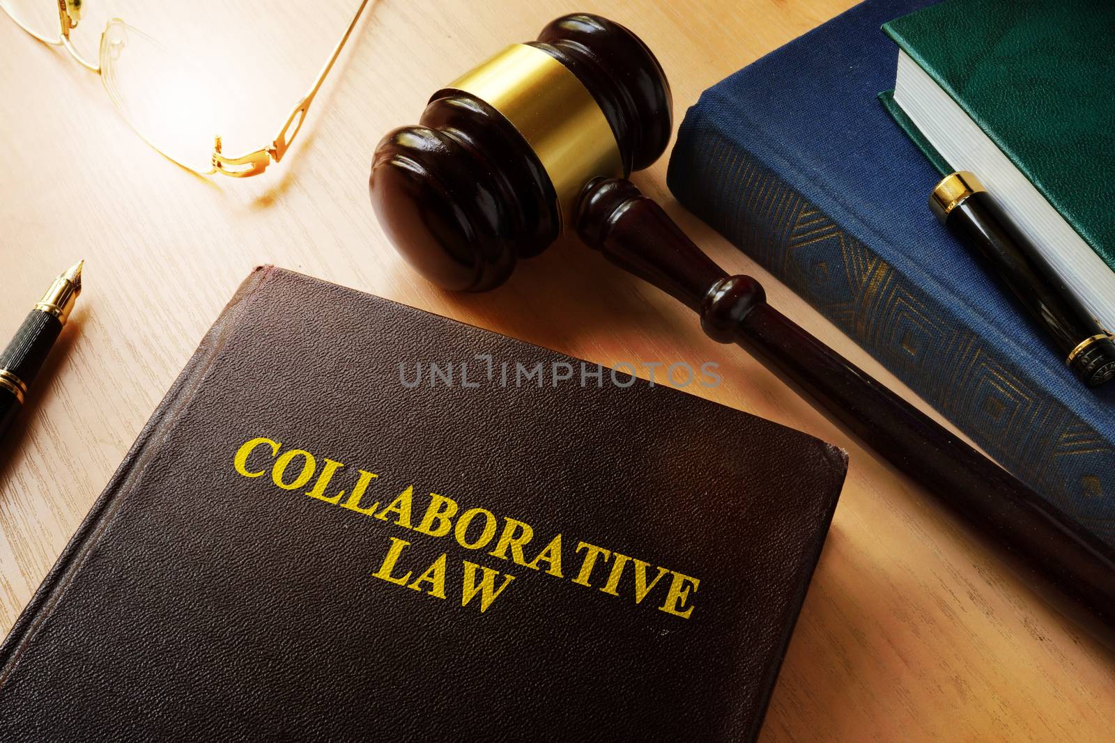 Collaborative law on a desk and gavel. by designer491