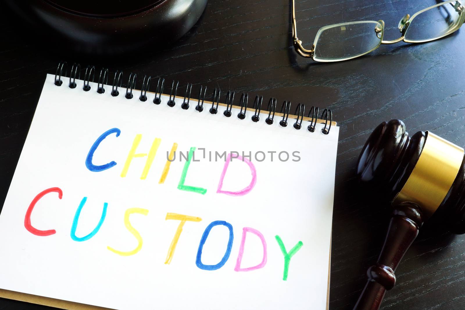 Child custody written in a note and gavel. Separation concept. by designer491