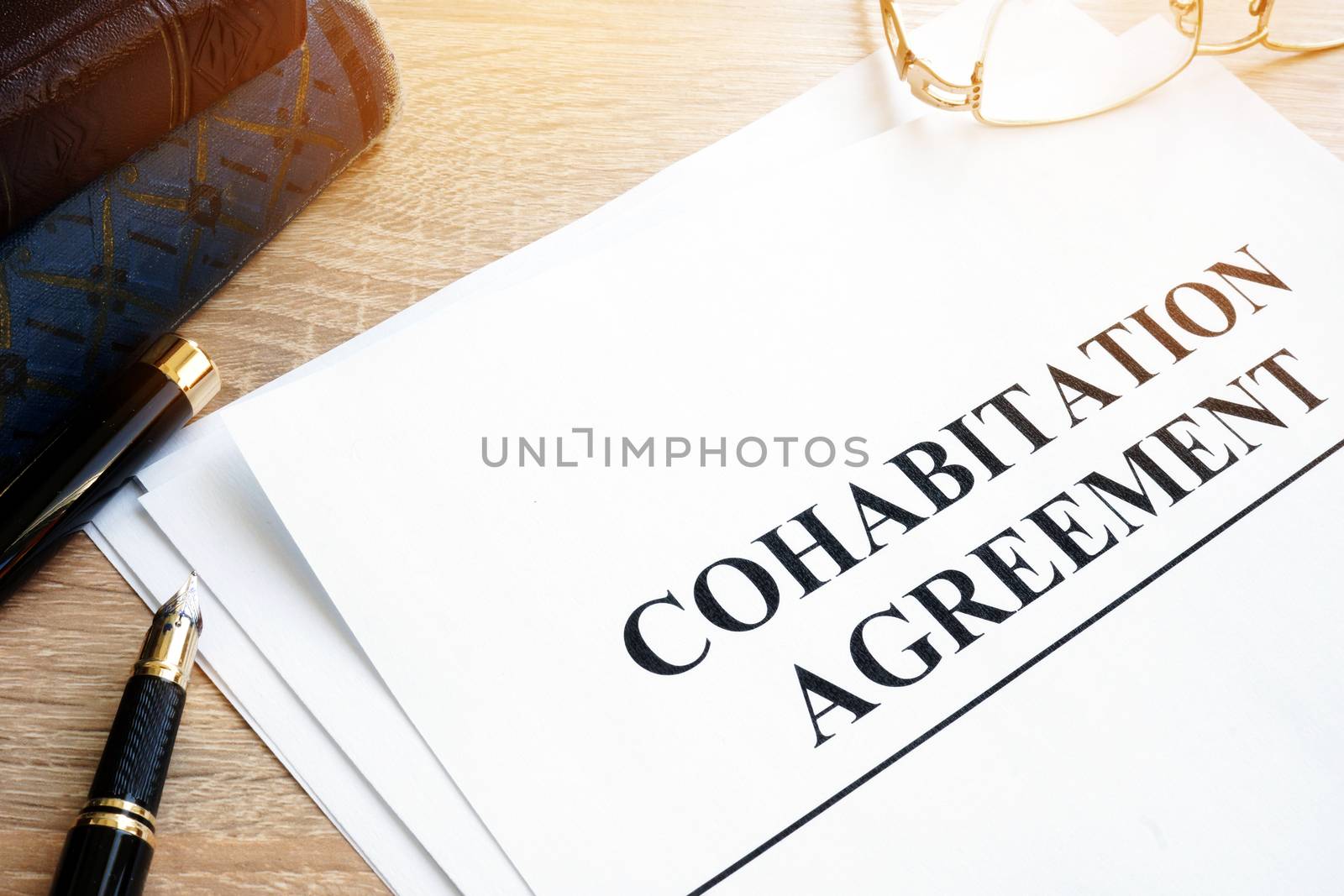 Cohabitation Agreement and books on a table. by designer491