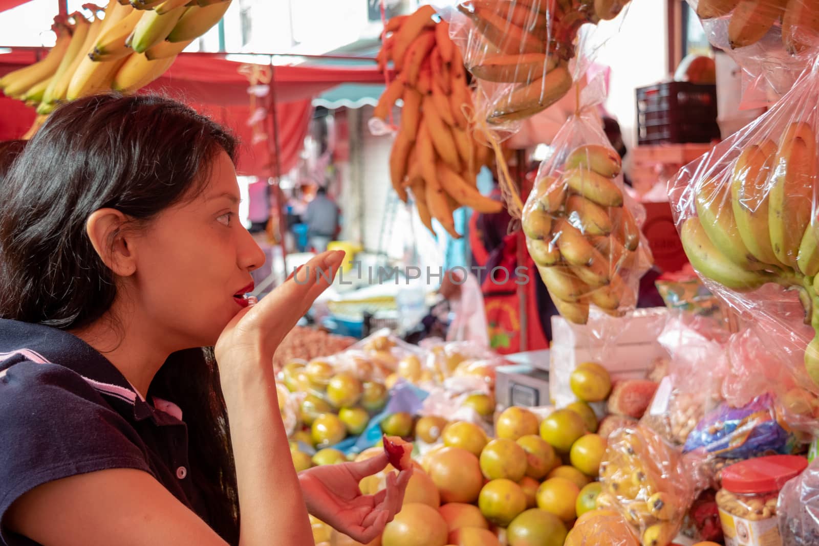 Woman buying some vegetables and fruits in a local mexican market