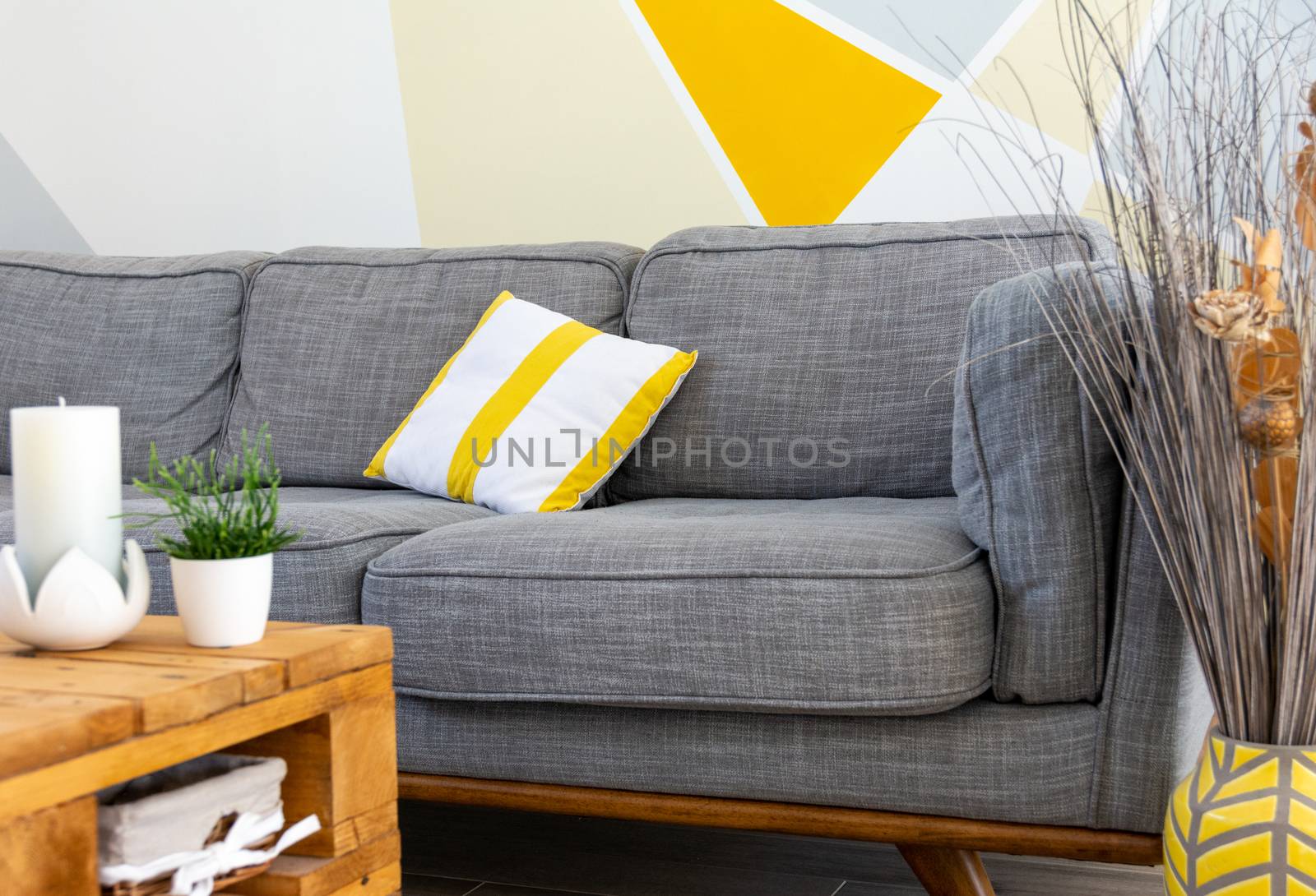 Stylish scandinavian style cozy living room interior with comfortable grey sofa