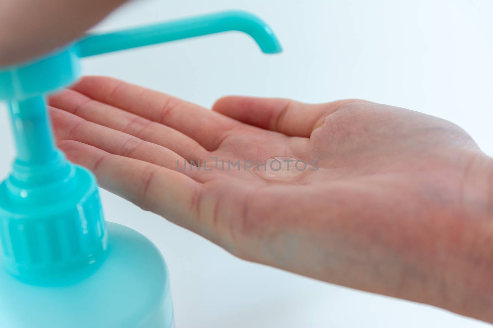 Woman washing hands with hand sanitizer alcohol antibacterial to prevent germs, bacteria and avoid coronavirus infections