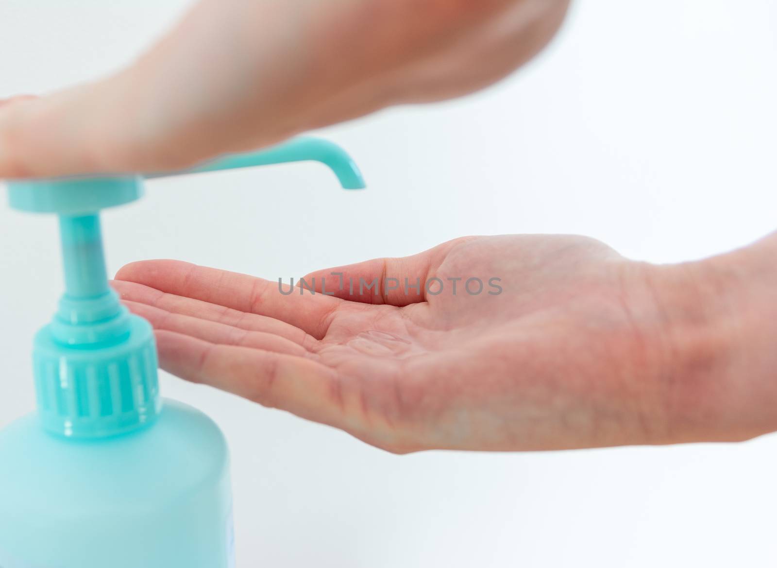 Woman washing hands with hand sanitizer alcohol antibacterial to prevent germs, bacteria and avoid coronavirus by nicousnake