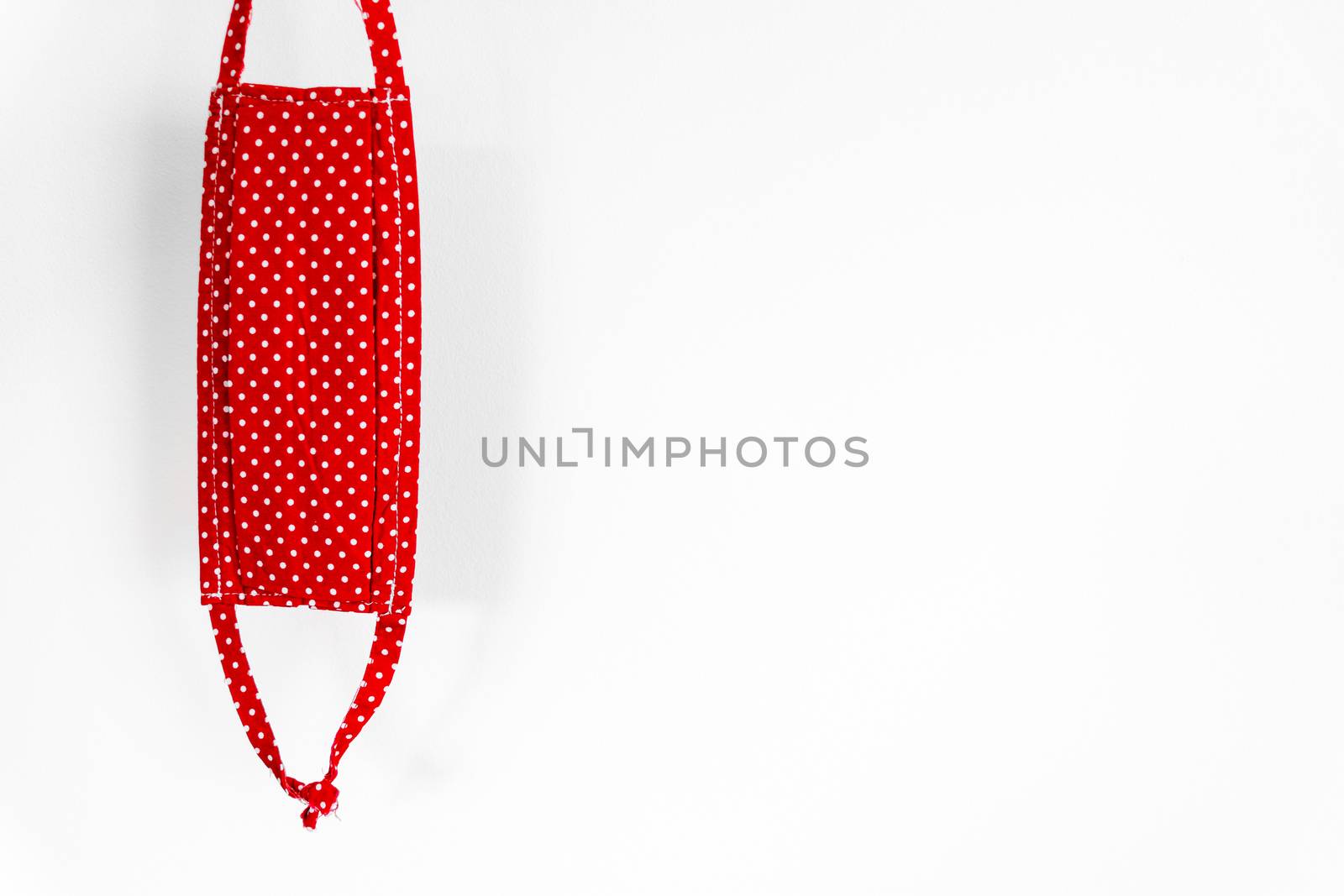 Modern red homemade mask used to protect against coronavirus isolated on white background
