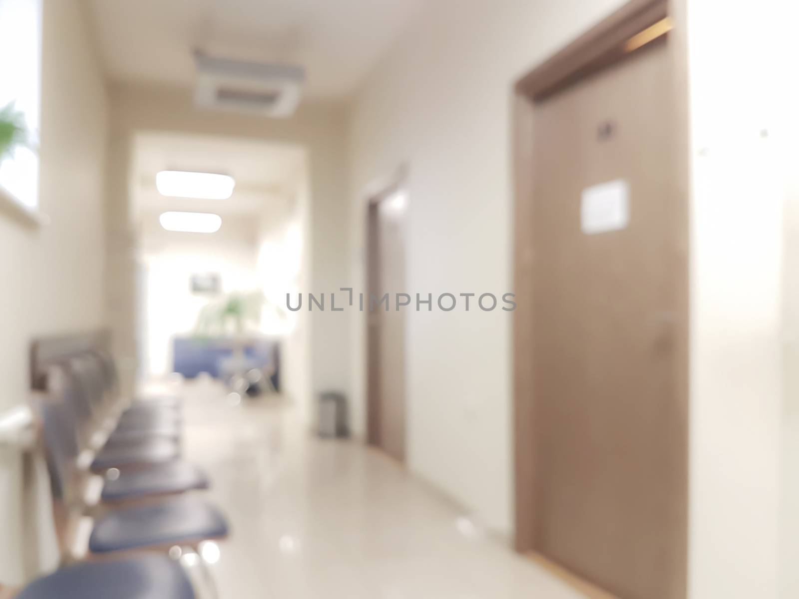 Blurred background waiting room in the doctor's office - chairs in the hallway and the door to the doctor's office