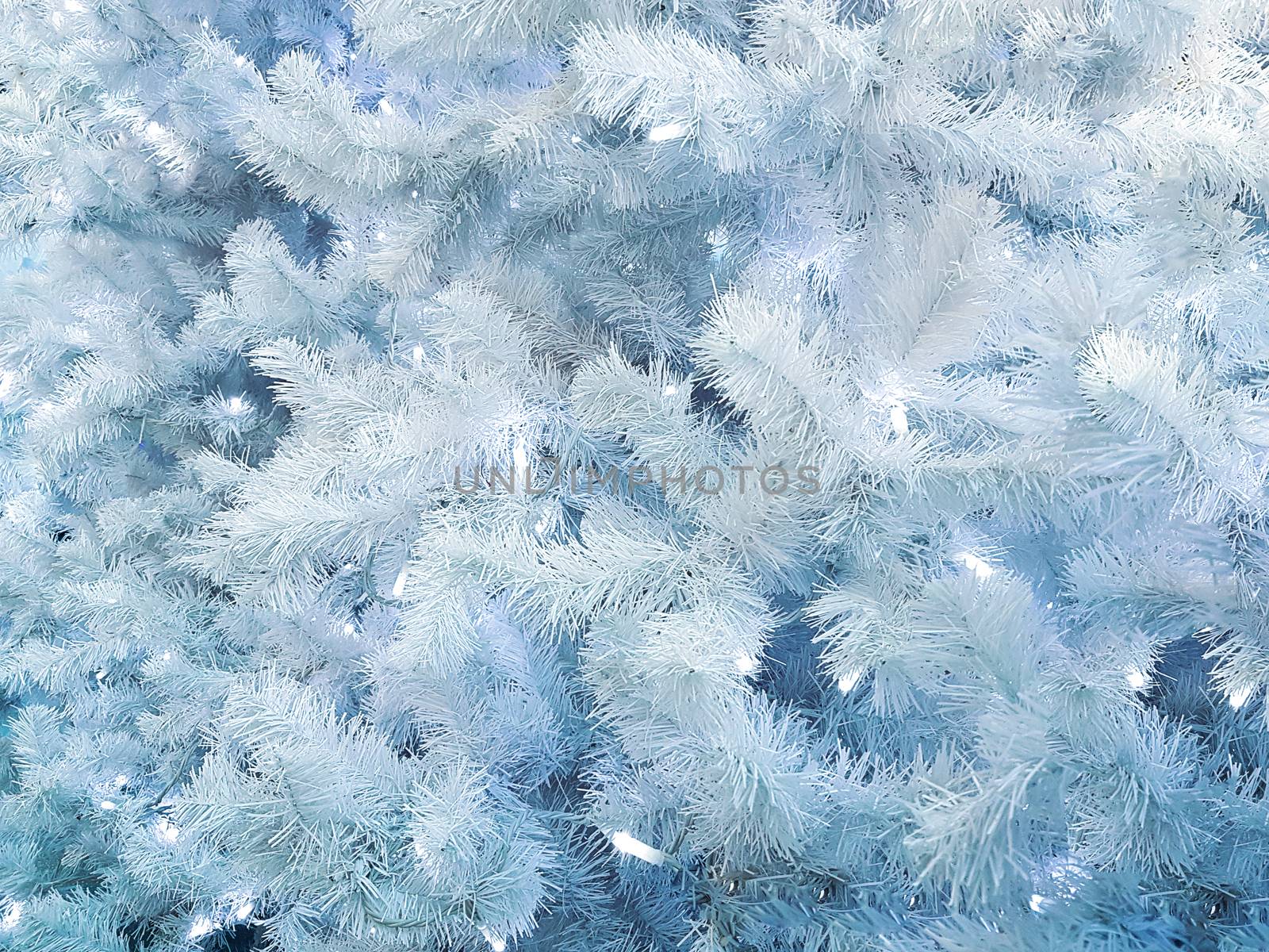 Concept of frozen and snowy trees with lights as beautiful White Christmas abstract background