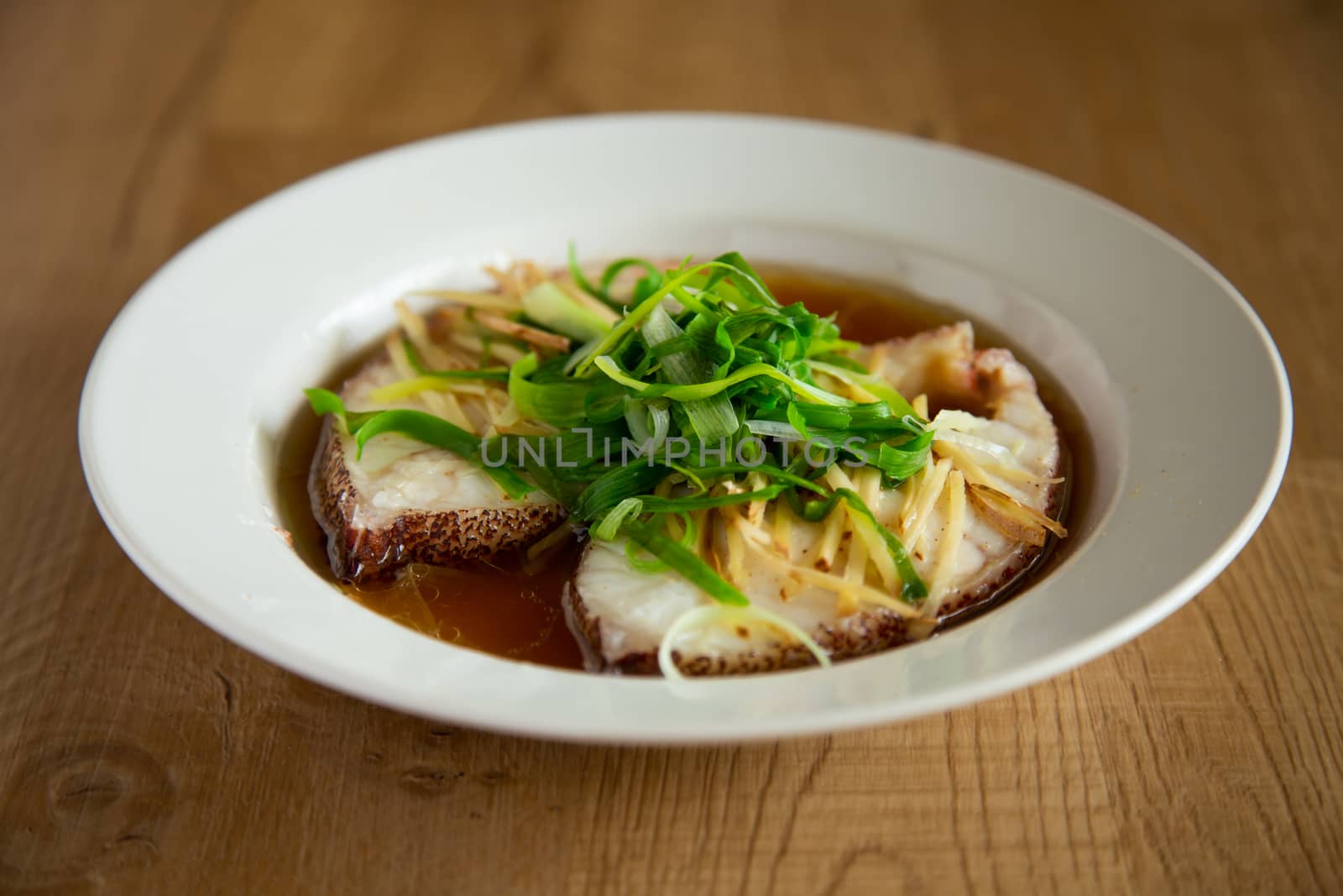 Asian chinese style steam fish on wooden background
