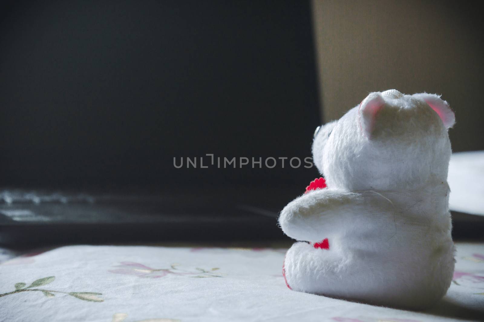 Teddy bear sitting in front of laptop computer device. Still Life. Child using digital technology. Conceptual background concept. Modern childhood education theme. Copy space room for text for massage.