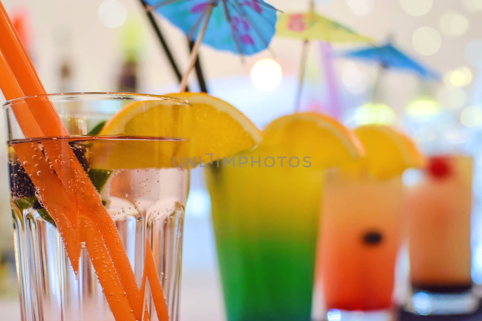 Various multi colored tropical coctail drinks in close-up (very low DOF).