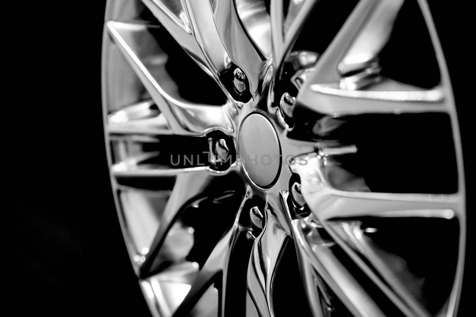 Luxury chrome alloy wheel in close-up as an automotive background (B&W HDR filter). 