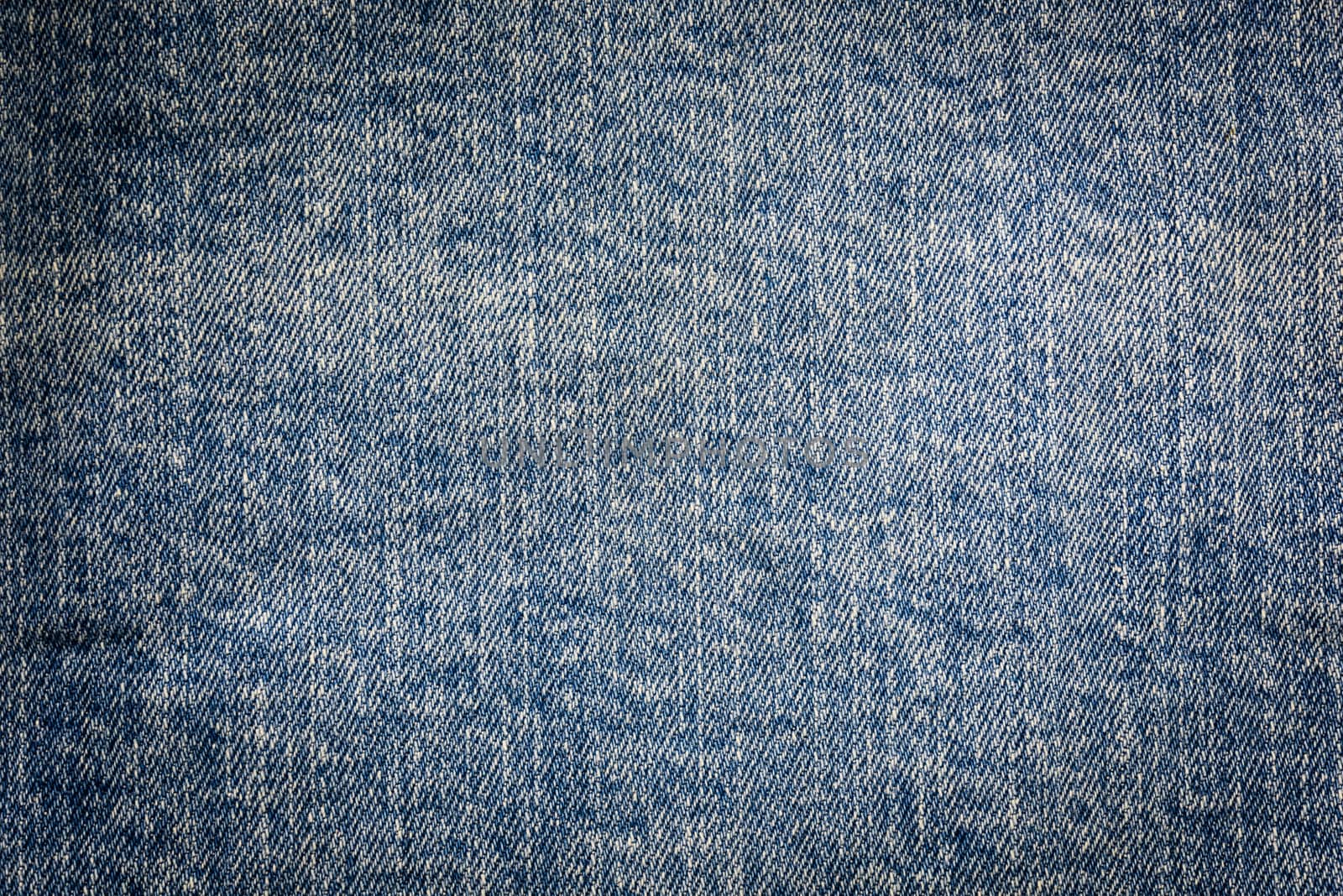 Textured vintage background - dirty blue jeans textile in close-up (high details)