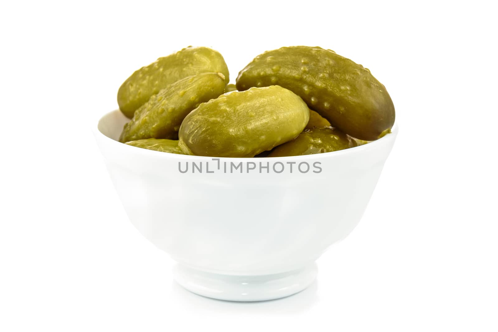 Bowl with pickled cucumbers on a white background in close-up