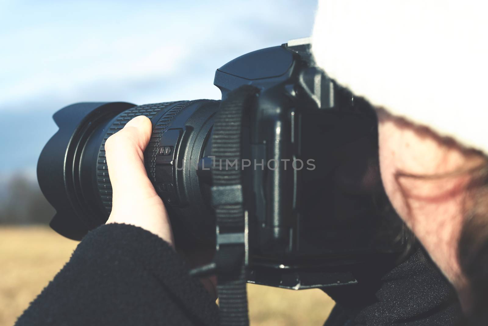 Young girl shoots outdoor photography with a DSLR camera in close-up ( vintage effect).