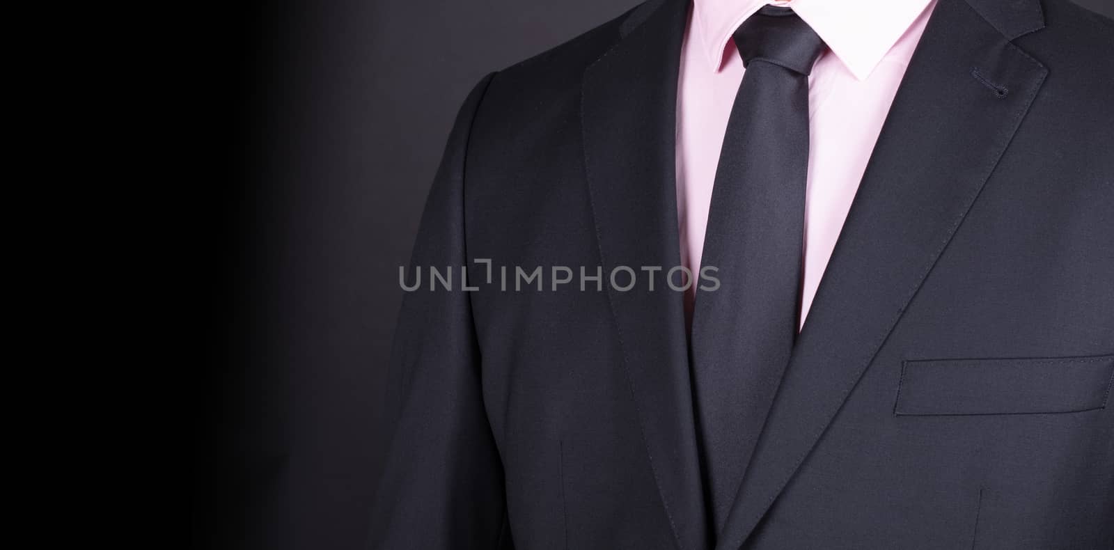 Man in a black suit with black tie, close-up