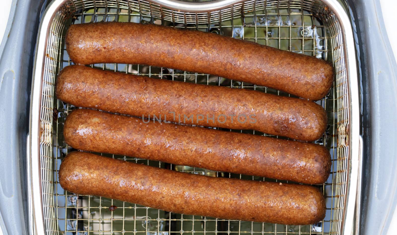 Frikadellen, a Dutch fast food snack in the oil, selective focus