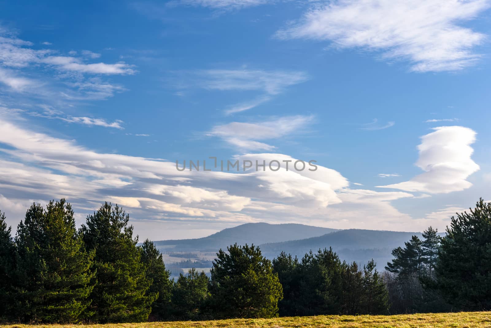 Beautiful landscape of mountains in autumn with a picturesque blue sky and clouds