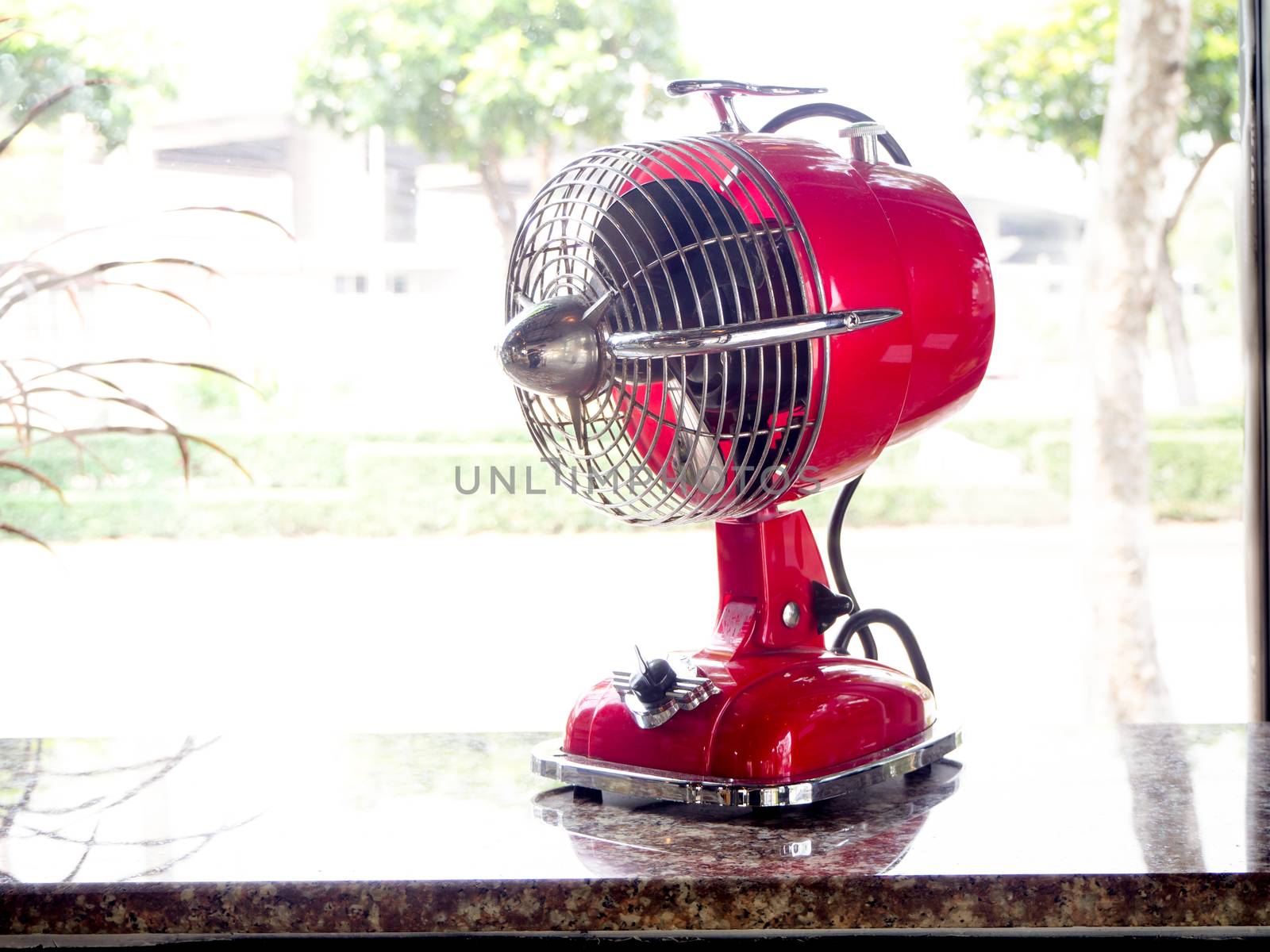 the red fan on a wooden table in cafe