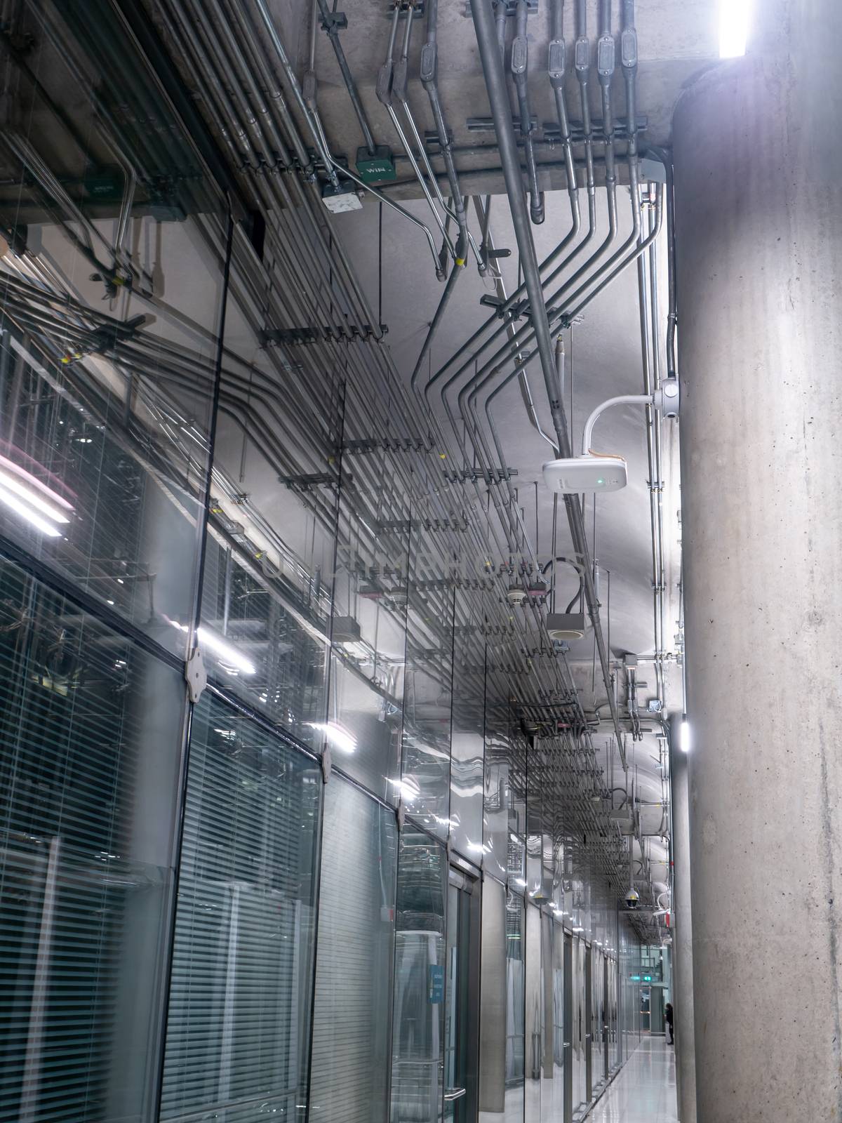 big windows passing daylight inside office building on modern glass building interior corridor