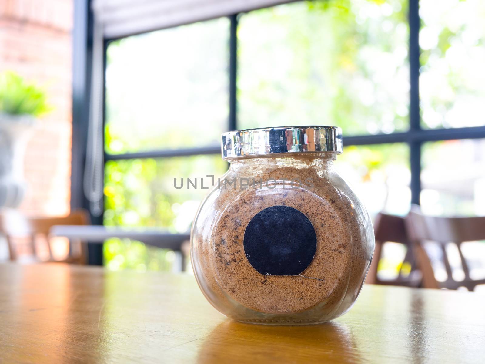 sugar in  glass jar on wood table for coffee.