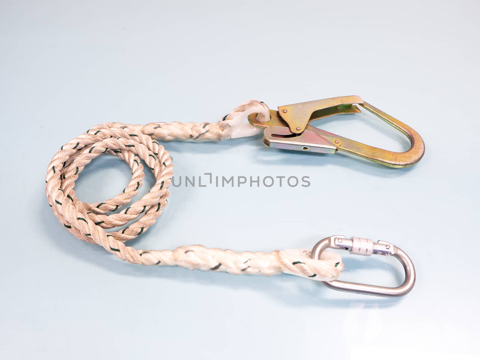 Figure eight knot with carabiner. Silver carabiner with lock andrope isolated on white background.