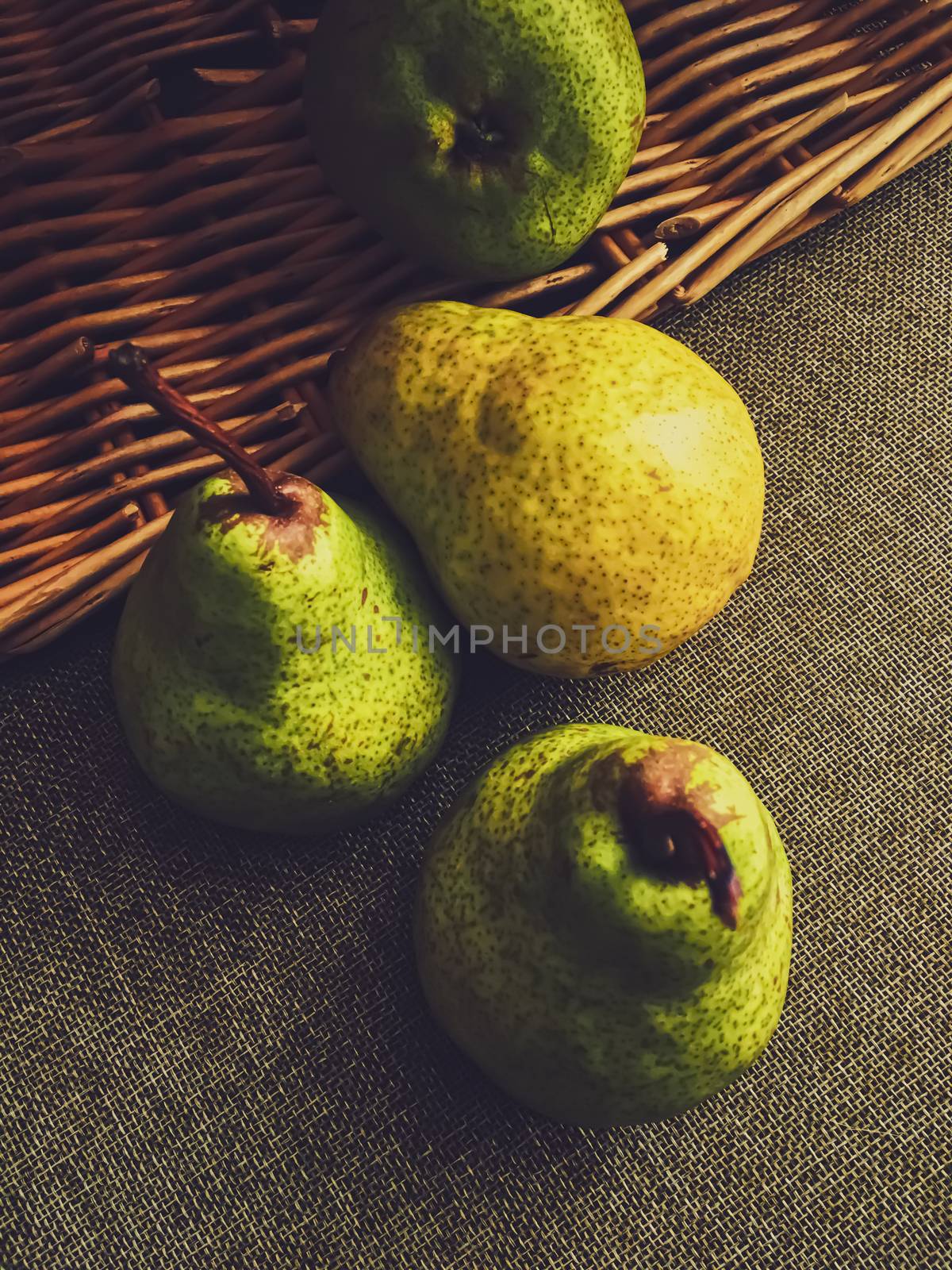 Organic pears on rustic linen background by Anneleven