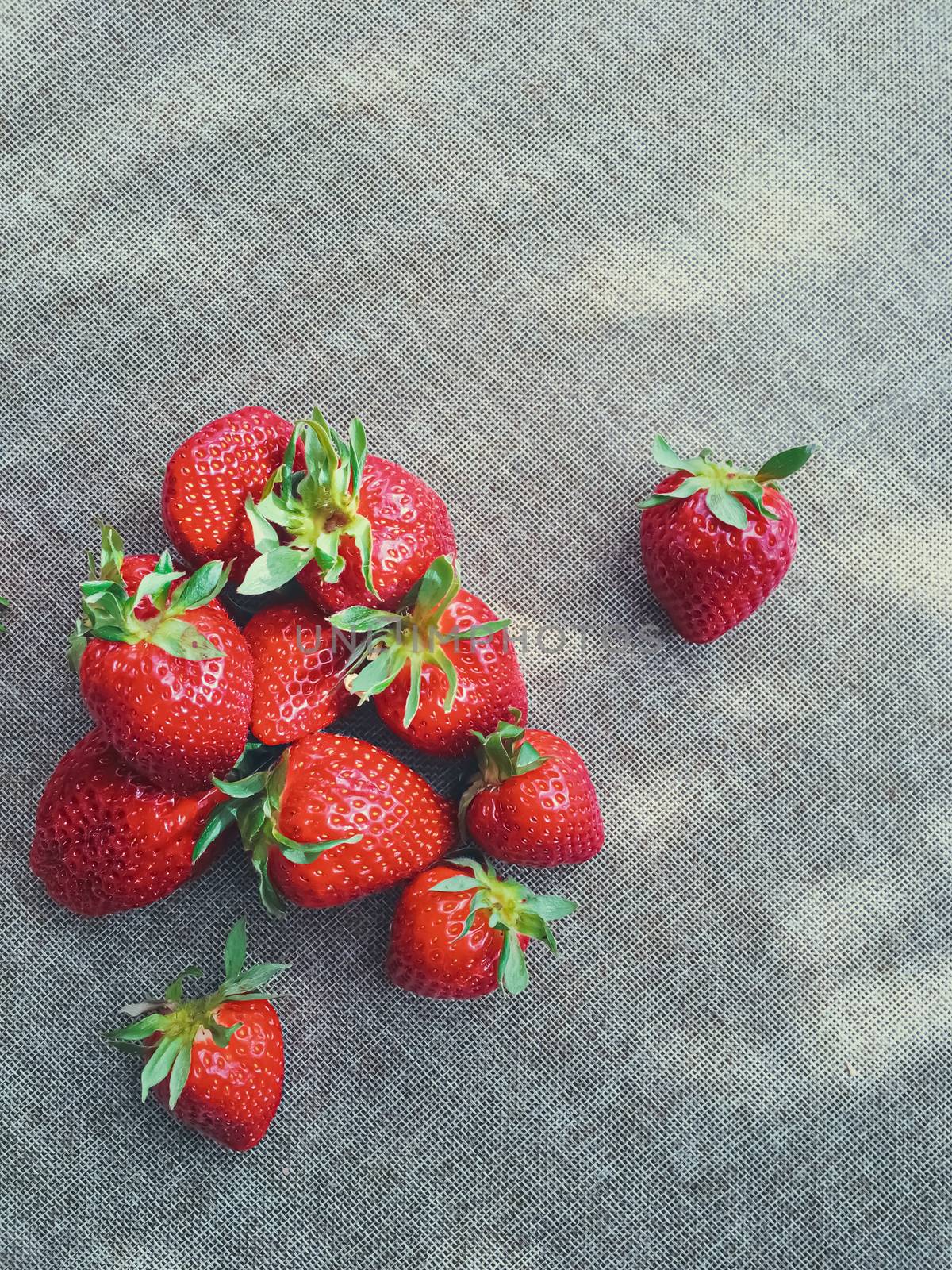 Organic strawberries on rustic linen background by Anneleven