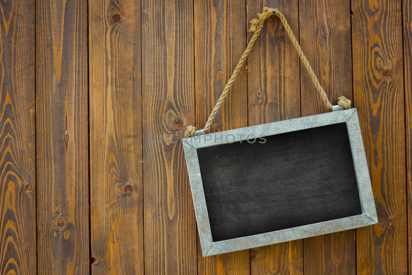 white space blackboard with rope on wooden door of a coffee shop. Copyspace on the left. Isolated. Clipping path