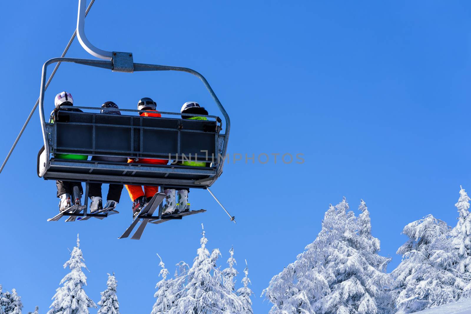 Skier sitting at ski lift by wdnet_studio