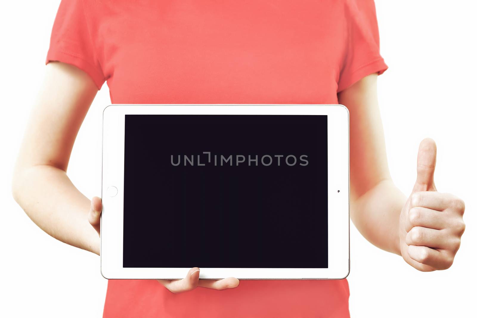 Technology advertising concept image - girl in red t-shirt holding digital tablet with blank screen and showing thumbs up gesture.
