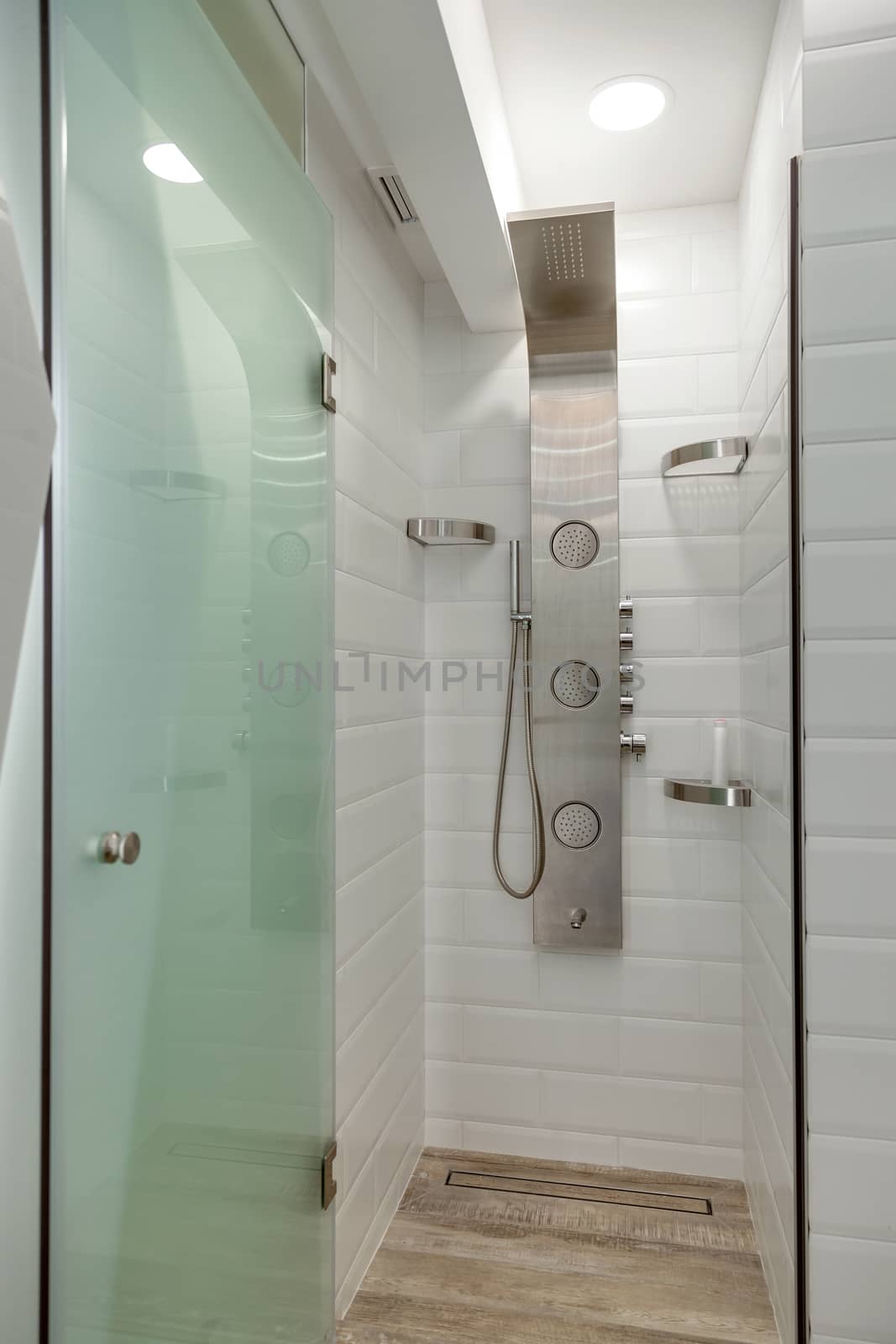 Modern white tiled shower room with chrome shower