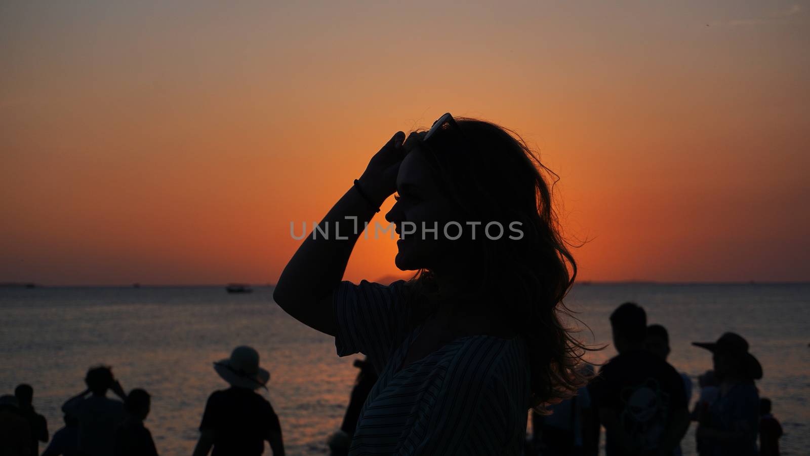 Side view of back light of a woman silhouette warm sunset in front of sun by natali_brill