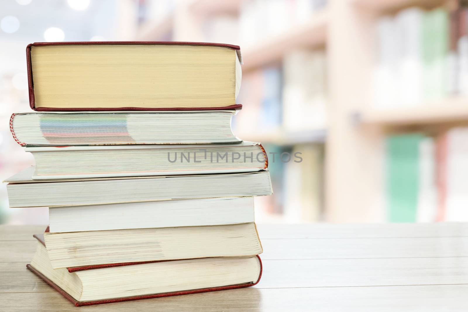 Concept image of education and learning - stocks of books on a desk in the library with copy space