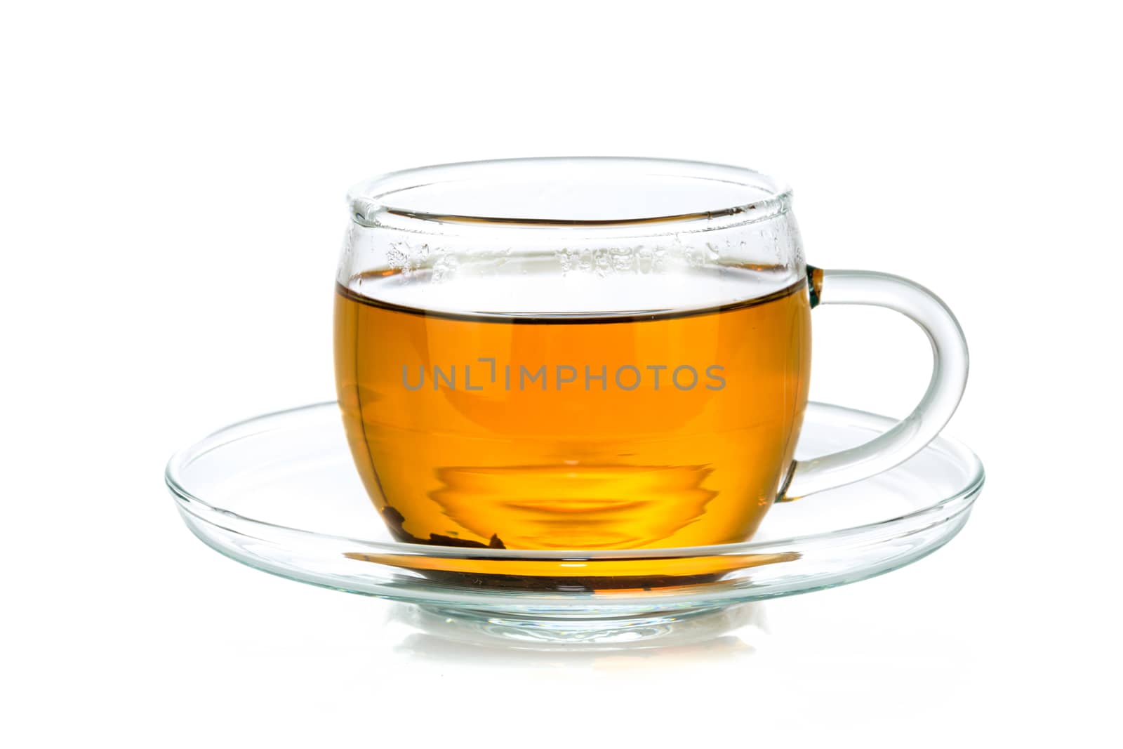 Transparent glass cup of tea isolated on a white background in close-up 